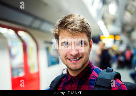 Close up, hipster man on platform against subway train Stock Photo