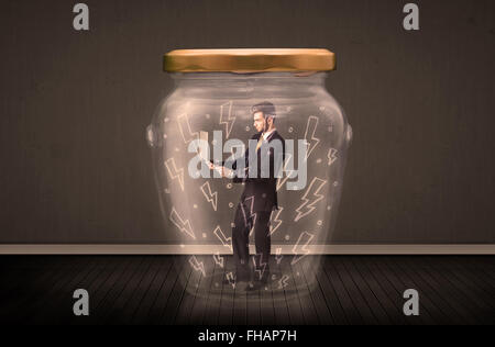 Businessman inside a glass jar with lightning drawings concept Stock Photo