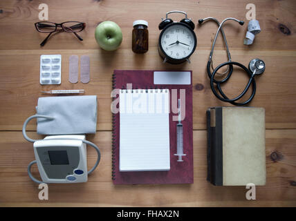 Medical objects laid out on a wooden table Stock Photo