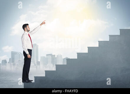 Businessman climbing up a concrete staircase concept Stock Photo