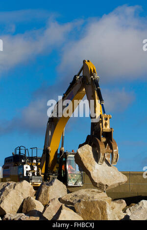 Blackpool, Fleetwood, Lancashire, UK. 24th February, 2016. Rossall Coastal defence £86million project resumes.  After recent storms and high winds, rock placement continues on the revetment at the southern end of the works with an additional 9,500 tonnes of primary rock placed. Primary rock placement now totals 95,000 tonnes and 171,500 tonnes of it have now been delivered to site.  Cernan Elias/Alamy Live News Stock Photo