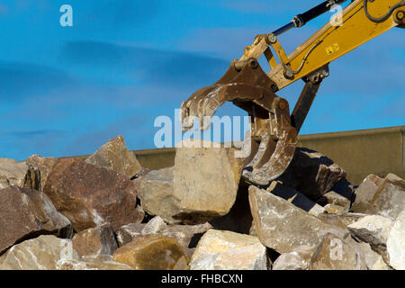 Heavy earth moving construction plant and equipment in Blackpool, Fleetwood, Lancashire, UK. 24th February, 2016. Rossall Coastal flood defence £86million project resumes.  After recent storms and high winds, rock placement continues on the revetment at the southern end of the works with an additional 9,500 tonnes of primary rock placed. Primary rock placement now totals 95,000 tonnes and 171,500 tonnes of it have now been delivered to site. Stock Photo