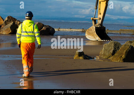 Blackpool, Fleetwood, Lancashire, UK. 24th February, 2016. Rossall Coastal defence £86million project resumes.  After recent storms and high winds, rock placement continues on the revetment at the southern end of the works with an additional 9,500 tonnes of primary rock placed. Primary rock placement now totals 95,000 tonnes and 171,500 tonnes of it have now been delivered to site.  Cernan Elias/Alamy Live News Stock Photo