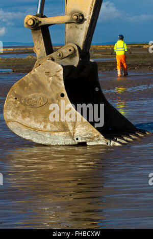 Blackpool, Fleetwood, Lancashire, UK. 24th February, 2016. Rossall Coastal defence £86million project resumes.  After recent storms and high winds, rock placement continues on the revetment at the southern end of the works with an additional 9,500 tonnes of primary rock placed. Primary rock placement now totals 95,000 tonnes and 171,500 tonnes of it have now been delivered to site.  Cernan Elias/Alamy Live News Stock Photo