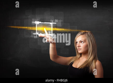 Young tech lady touching button with orange light beams concept Stock Photo