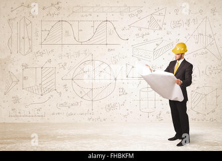 Handsome engineer calculating with hand drawn background Stock Photo