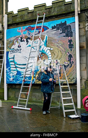 A member of Artists for Justice and Peace working on a mural at St John's Episcopal Church in Edinburgh. Stock Photo