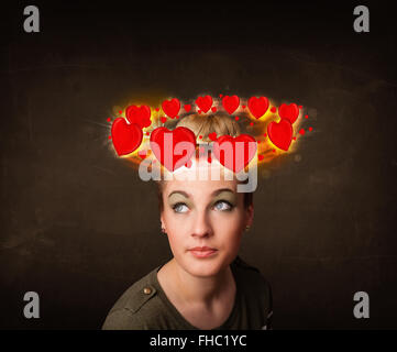 teenager girl with heart illustrations circleing around her head Stock Photo