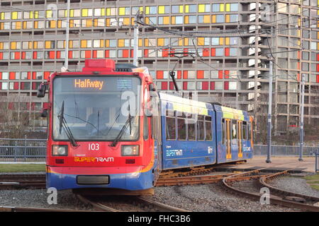 A tram passes by a refurbished block of apartments on the Park hill housing estate in the centre of the City of Sheffield, UK Stock Photo