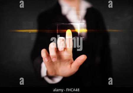 Young tech lady touching button with orange light beams concept Stock Photo