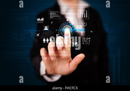 Young businesswoman touching future web technology buttons and icons Stock Photo