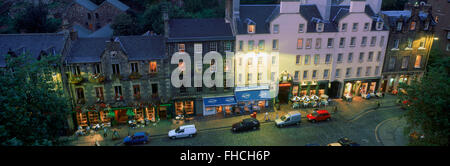 Panoramic overview of cars parked at old pubs along Grassmarket in Edinburgh in dusk light in Scotland Stock Photo