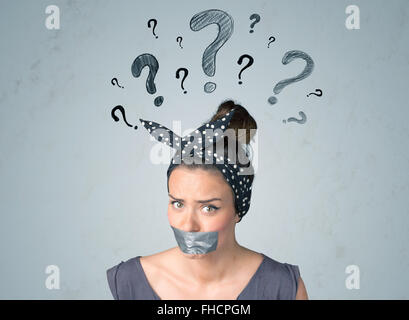 Young woman with glued mouth and question mark symbols Stock Photo