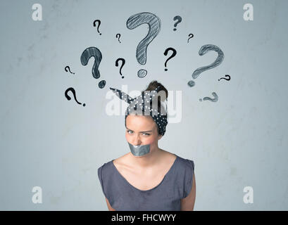 Young woman with glued mouth and question mark symbols Stock Photo