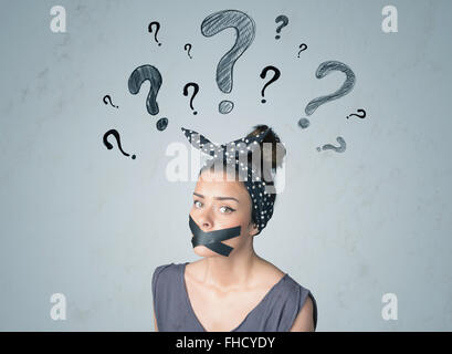 Young woman with glued mouth and question mark symbols Stock Photo