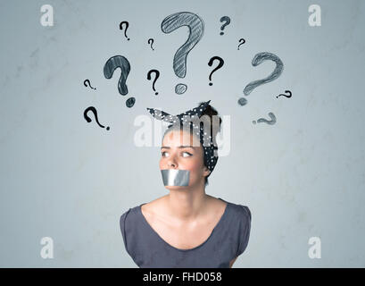 Young woman with glued mouth and question mark symbols Stock Photo