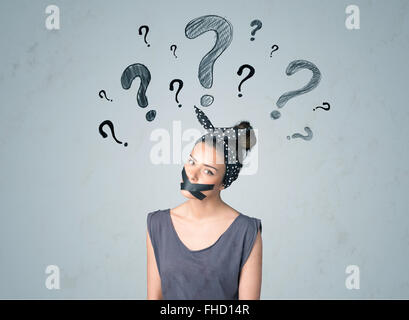 Young woman with glued mouth and question mark symbols Stock Photo