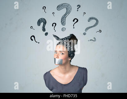 Young woman with glued mouth and question mark symbols Stock Photo