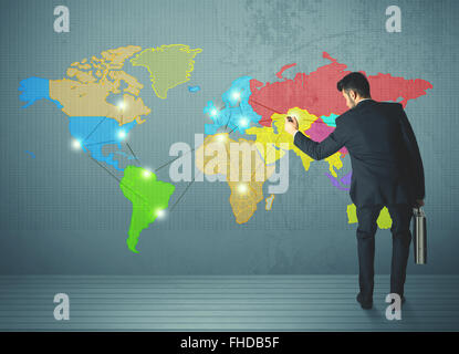 businessman drawing map on wall Stock Photo