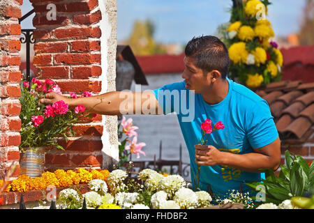 GRAVES are covered with FRESH FLOWERS to welcome loved ones back to earth during DAY OF THE DEAD -  SAN MIGUEL DE ALLENDE, MEXIC Stock Photo