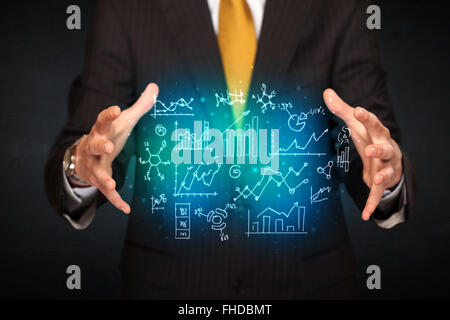 holding hand drawn business diagrams Stock Photo