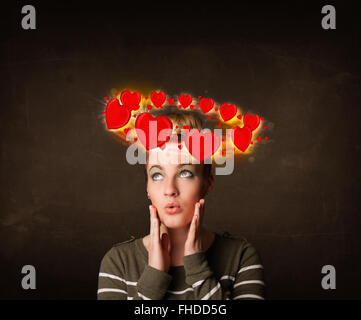 teenager girl with heart illustrations circleing around her head Stock Photo