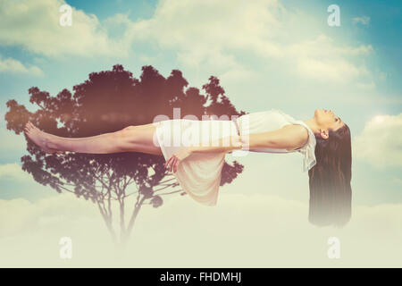 Composite image of girl in white dress floating in air Stock Photo