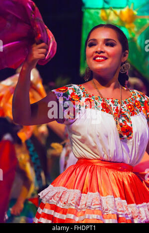 A female FOLK DANCER performs in the Plaza de la Danza during the GUELAGUETZA FESTIVAL in July - OAXACA, MEXICO Stock Photo