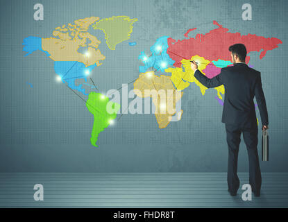 businessman drawing map on wall Stock Photo