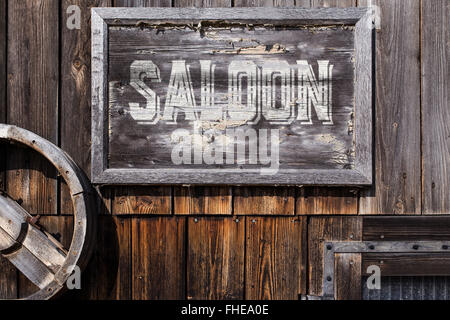 wooden sign with word saloon, planks on the background, vintage style Stock Photo