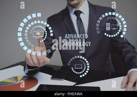 hand pushing advanced technology button on a touch screen interface Stock Photo