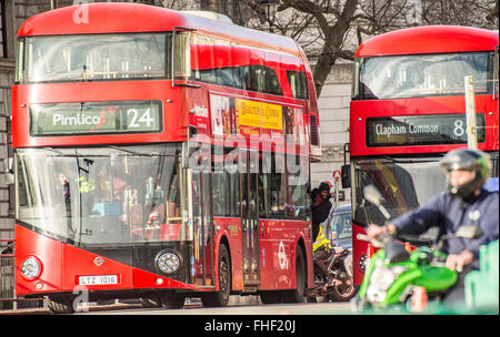 Man leaning out of London bus Stock Photo