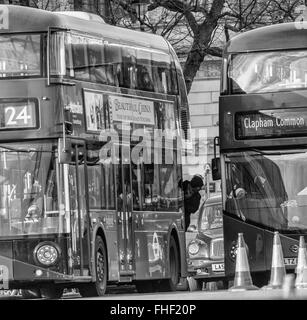 Man leaning out of London bus Stock Photo