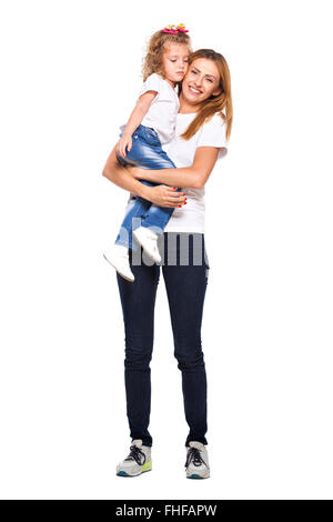 young mother holds her daughter in her arms with love, smiling, isolated on white Stock Photo