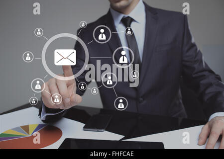 Businessman clicking on email icon. mail service Stock Photo