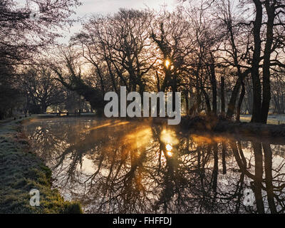 River Wey navigation at Newark lock near Ripley Surrey on a still clear frosty winters morning with contre jour lighting Stock Photo