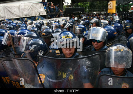 Philippines. 25th Feb, 2016. Crowd control police officers block Ortigas Avenue inQuezon City. Militant activists clashed with the police as they try to march towards EDSA Shrine in Quezon City. The protesters are calling for 'real'' democracy on the 30th anniversary of the EDSA People Power revolution with toppled president Ferdinand Marcos. © J Gerard Seguia/ZUMA Wire/Alamy Live News Stock Photo