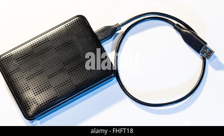 Portable external HDD hard disk drive with USB cable on white background. Stock Photo