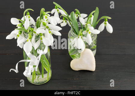 Fresh snowdrops bouquet on dark wooden table Stock Photo