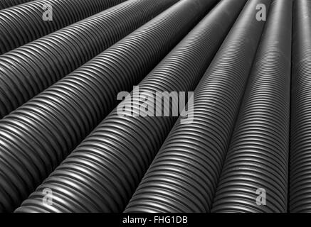 Big black plastic pipes lie side by side Stock Photo