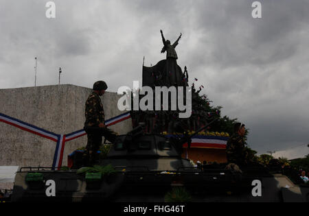 A Filipino soldier stands on a military tank during the celebration of 30th anniversary of EDSA People Power Revolution. The popular uprising of 1986 ended the two decades dictatorial rule of late Ferdinand Marcos. President Aquino in his speech hit the Marcos family in refusing to apologize to Martial Law victims. Marcos’ son, Bongbong Marcos, a current senator is running for vice president in the coming May 9 elections. Martial Law victims were campaigning to oppose Sen. Marcos’ vice presidential bid, a way for his family to return in power. (Photo by Marlo Cueto / Pacific Press) Stock Photo
