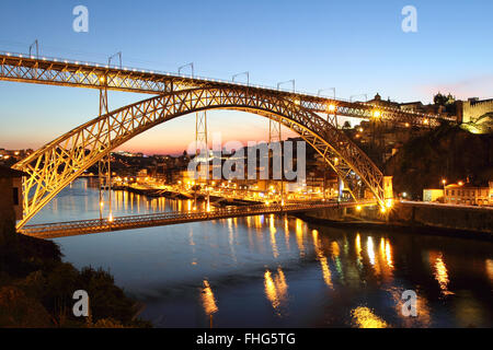 Dom Luiz bridge at dusk and Porto cityscape in background. Portugal Stock Photo