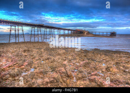English Victorian pier Birnbeck island Weston-super-Mare Somerset England in colourful HDR with rock pools and rocks Stock Photo