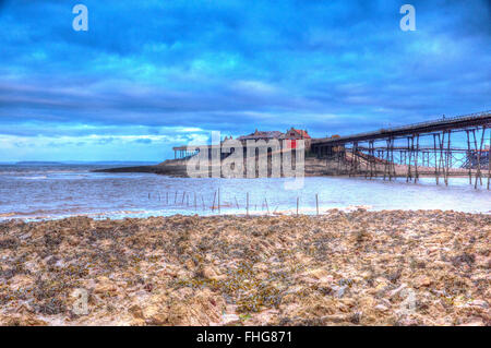 English Victorian pier Birnbeck island Weston-super-Mare Somerset England in colourful HDR with rock pools and rocks Stock Photo