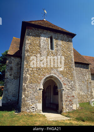 A C13th, two-storeyed S porch (low tower with upper bell chamber) added to the C11th Saxon nave of St Andrew's Church, West Stoke, West Sussex. Stock Photo