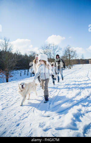 Family walking together in the snow Stock Photo