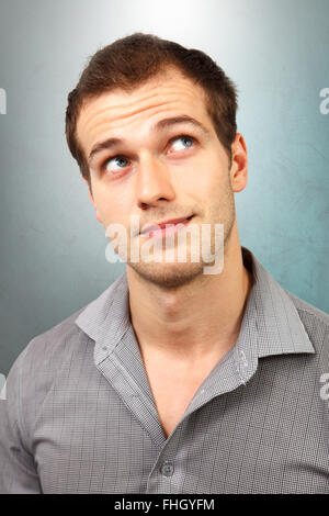 Pensive thinking young man looking up Stock Photo