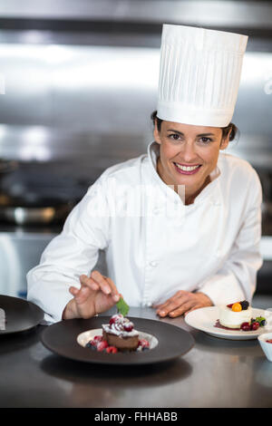 Chef putting finishing touch on dessert Stock Photo