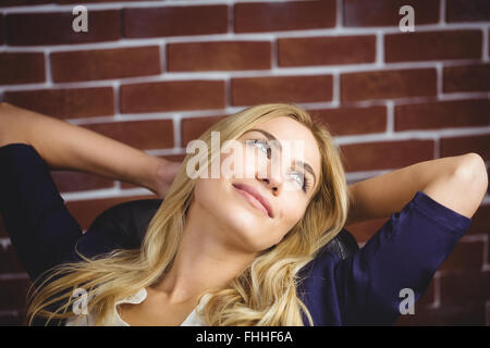 Blonde woman relaxing in chair Stock Photo