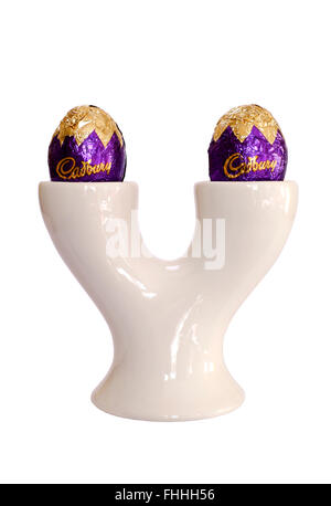 chocolate easter eggs in double egg cup holder cut out on a white background Stock Photo